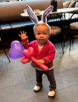 Child holding balloon creations