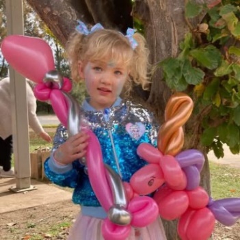 Child holding deluxe balloon creations