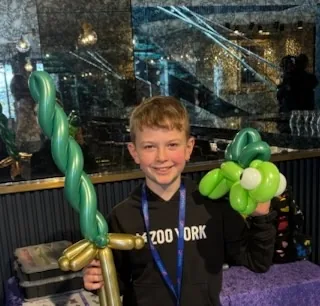 Child enjoying a balloon creation