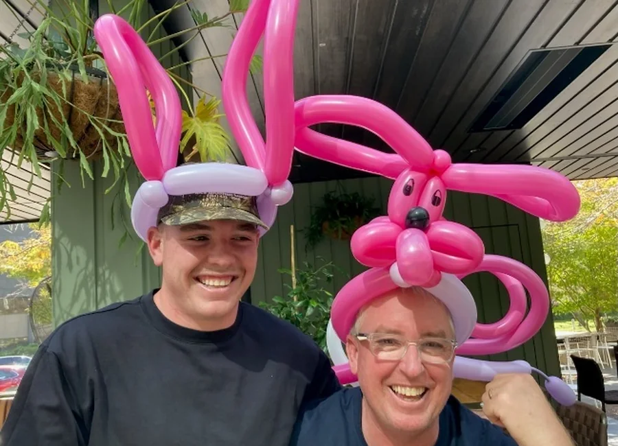 Entertainers wearing balloon creations