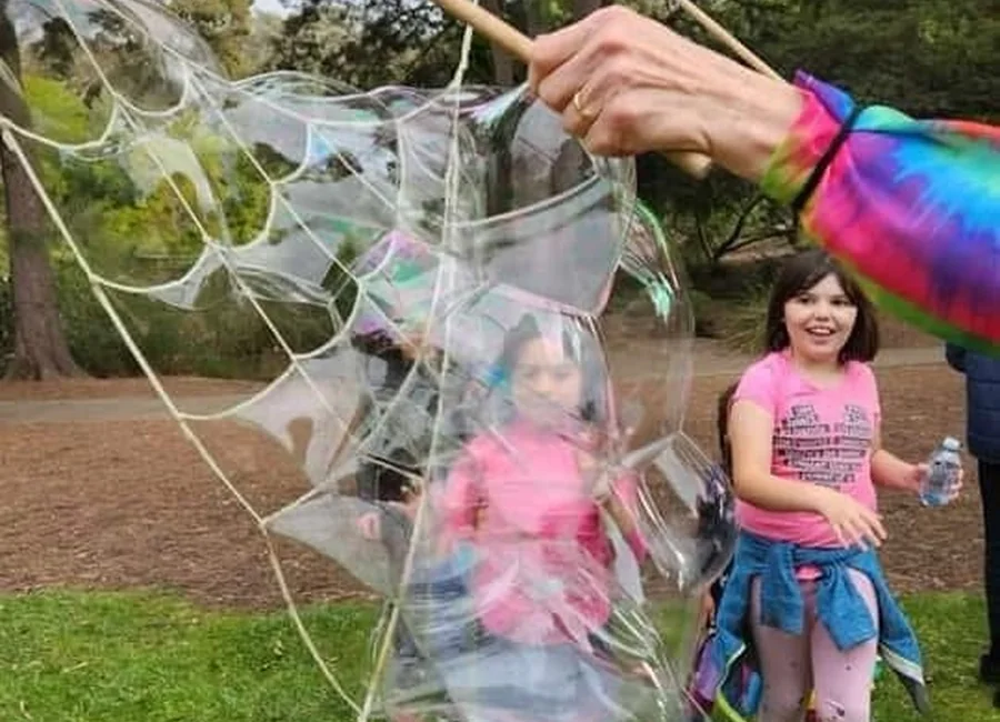 Children enjoying giant outdoor bubbles